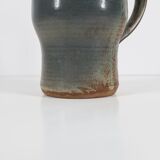 Handcrafted stoneware pitcher with blue-green hues, signed piece