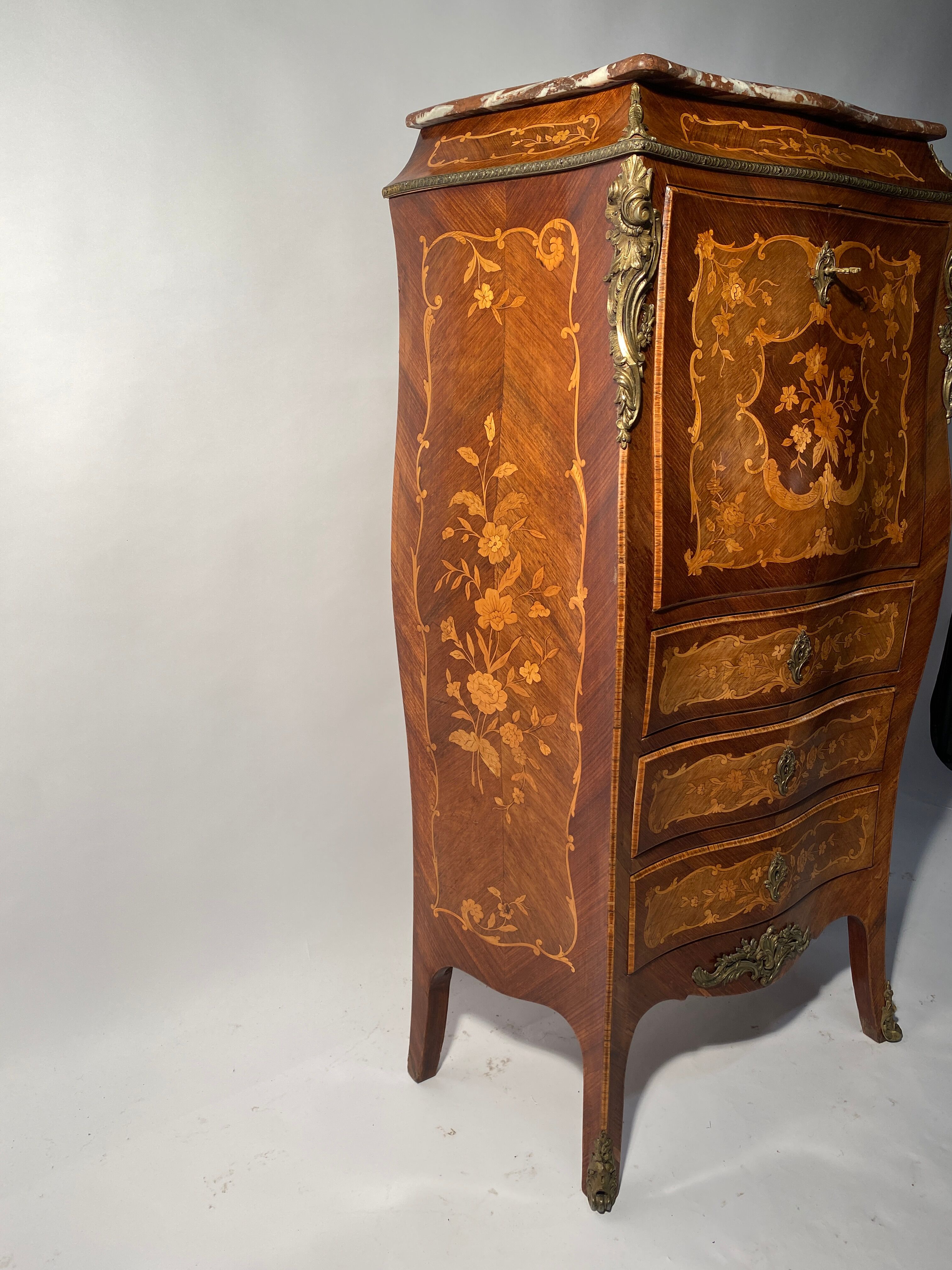 Curved secretary and inlaid with floral branches in Louis XV style