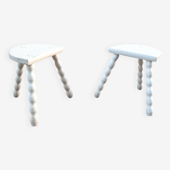 Duo of milking stools with turned legs.