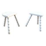 Duo of milking stools with turned legs.