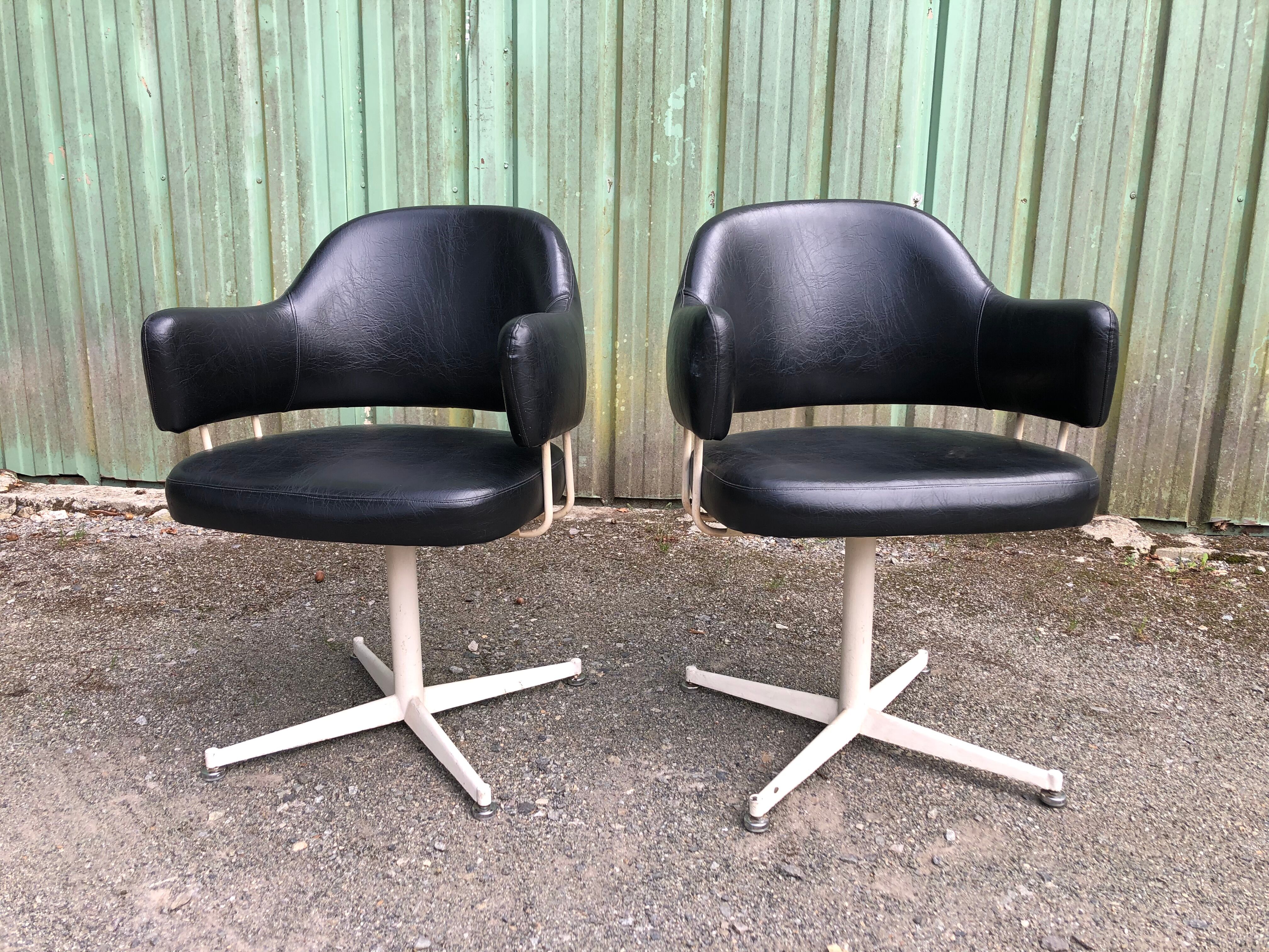 Pair of vintage armchairs in black skai with metal legs.