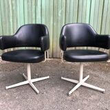 Pair of vintage armchairs in black skai with metal legs.