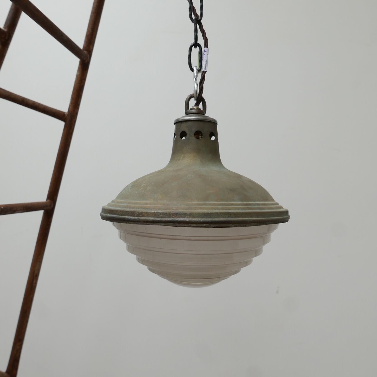 Patinated metal and glass Holophane pendant light
