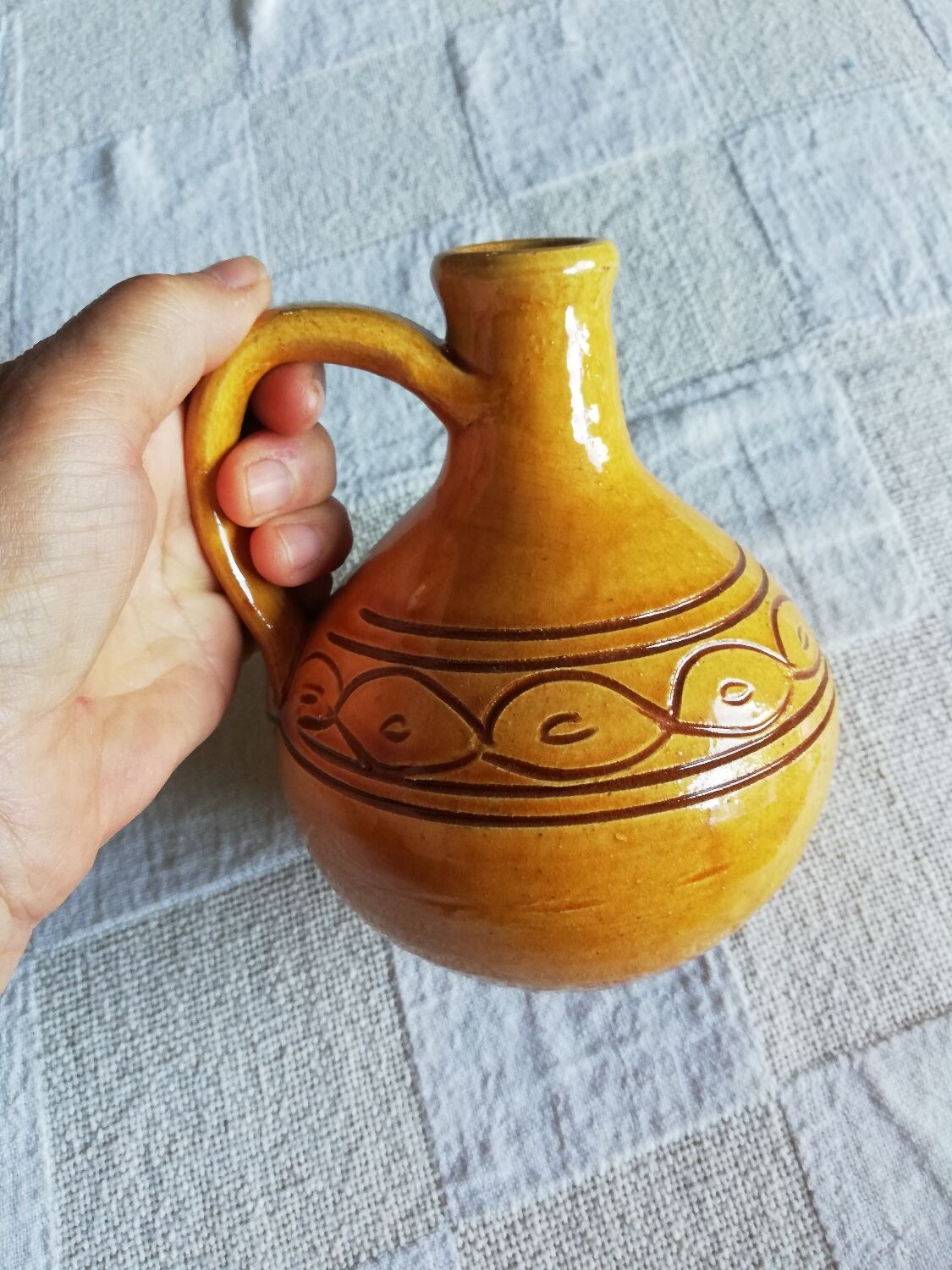Round ochre glazed jug with handle