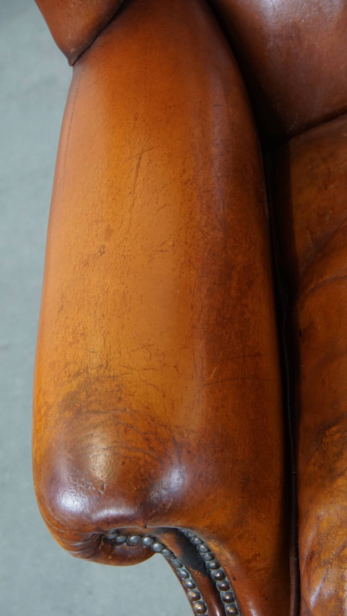 Sheepskin leather wingback chair with patina