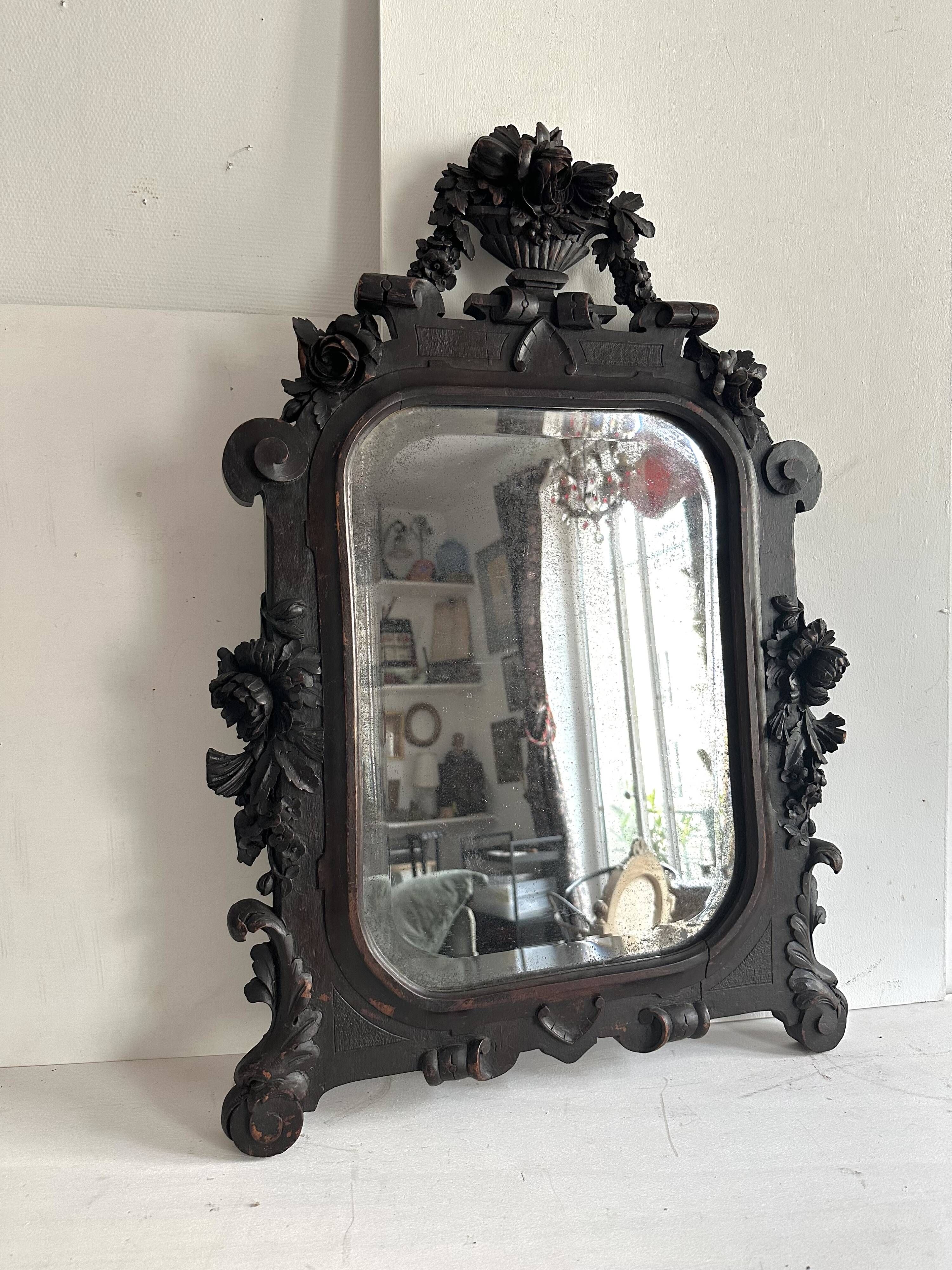 Napoleon III mirror in carved blackened wood, 19th century