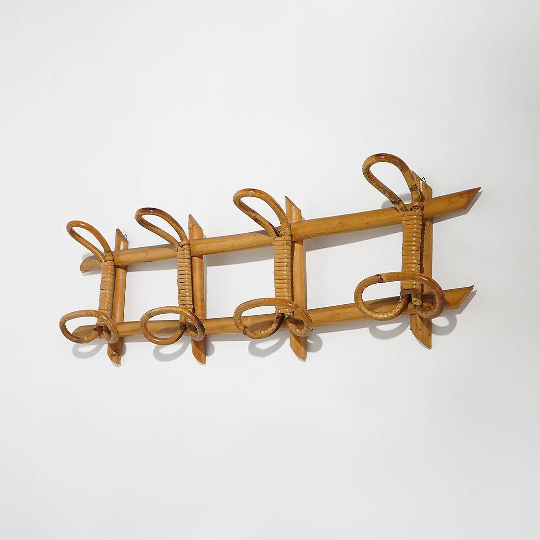 Wall coat rack in rattan and woven wicker, 1960s.