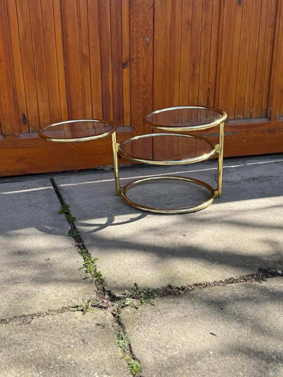 1970s swivel coffee table in gilded brass and glass, Milo Baughman style, vintage design.