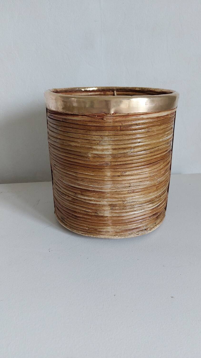 Rattan and brass pot cover