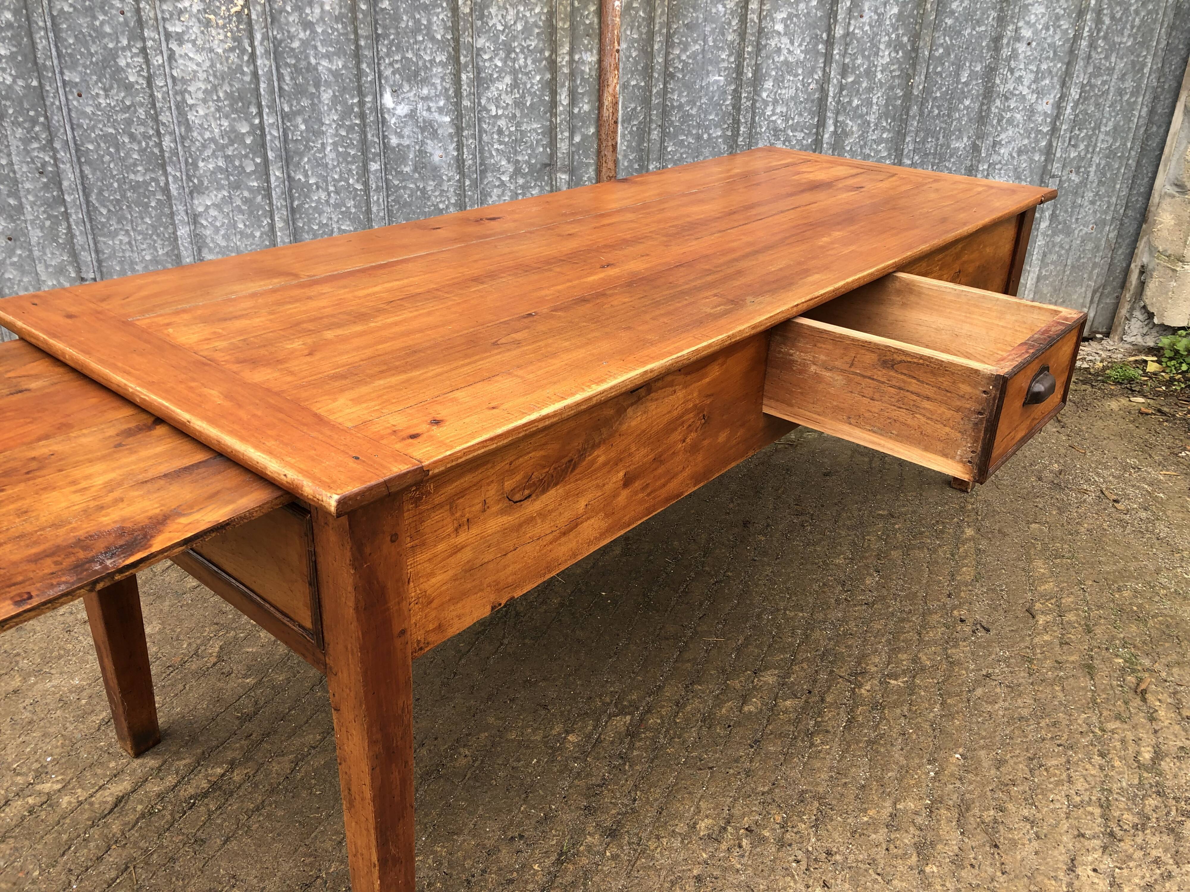Antique farmhouse table in solid cherry wood with 3 drawers and 1 pull-out.