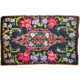 Bohemian floral design, handwoven wool rug, black background with colorful flowers
