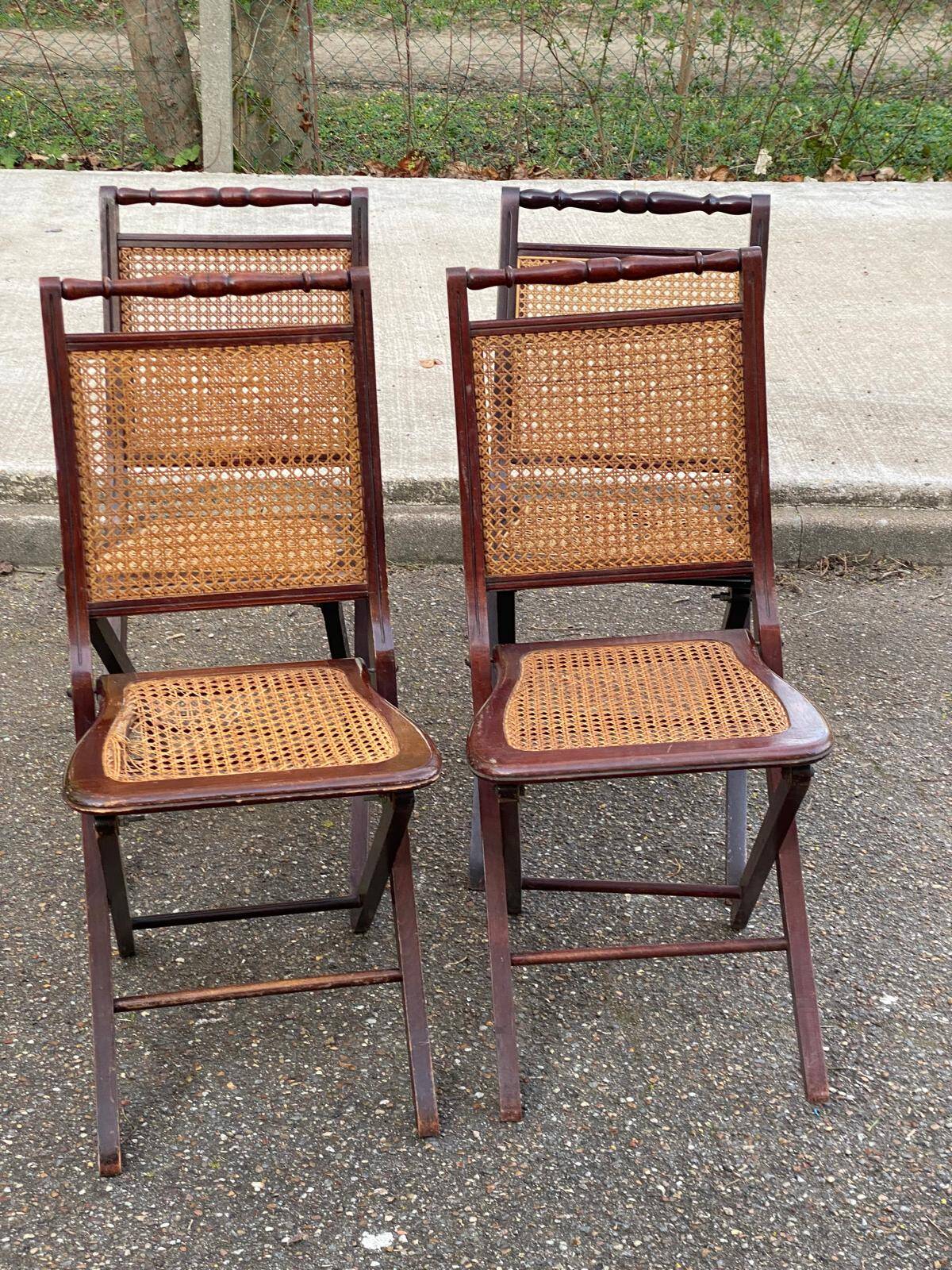 4 cane-seated solid wood folding chairs to be repaired.
