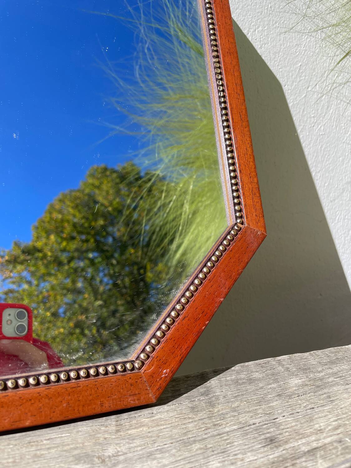 Octagonal beaded wooden mirror