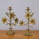 Pair of church candlesticks in bronze with floral decorations.