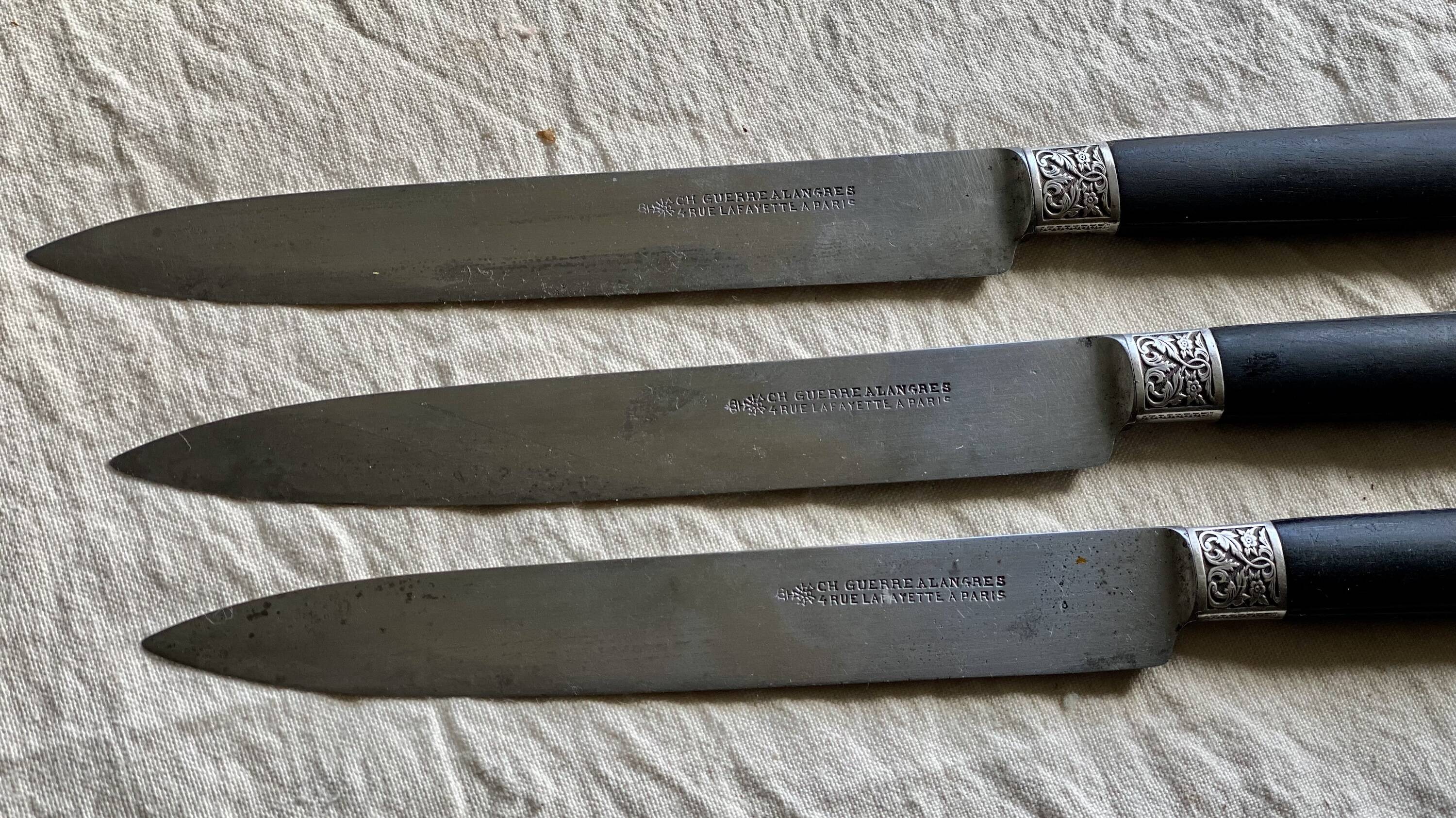 Set of 12 19th century table knives with ebony and chiseled silver handles