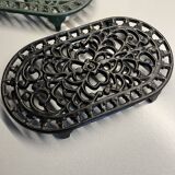 Duo of antique cast iron table mats