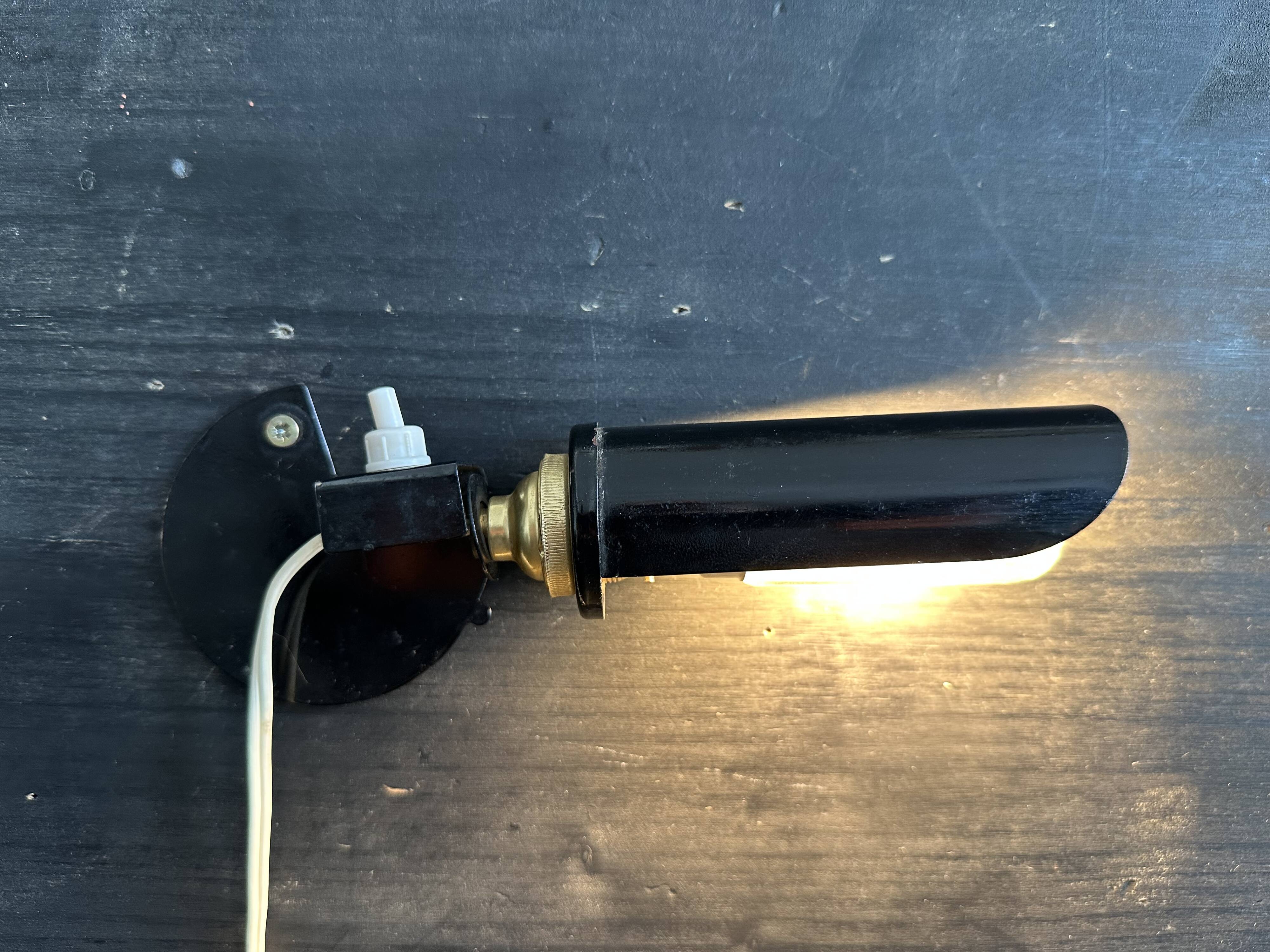 Old black metal and brass wall light, adjustable, 1930s.