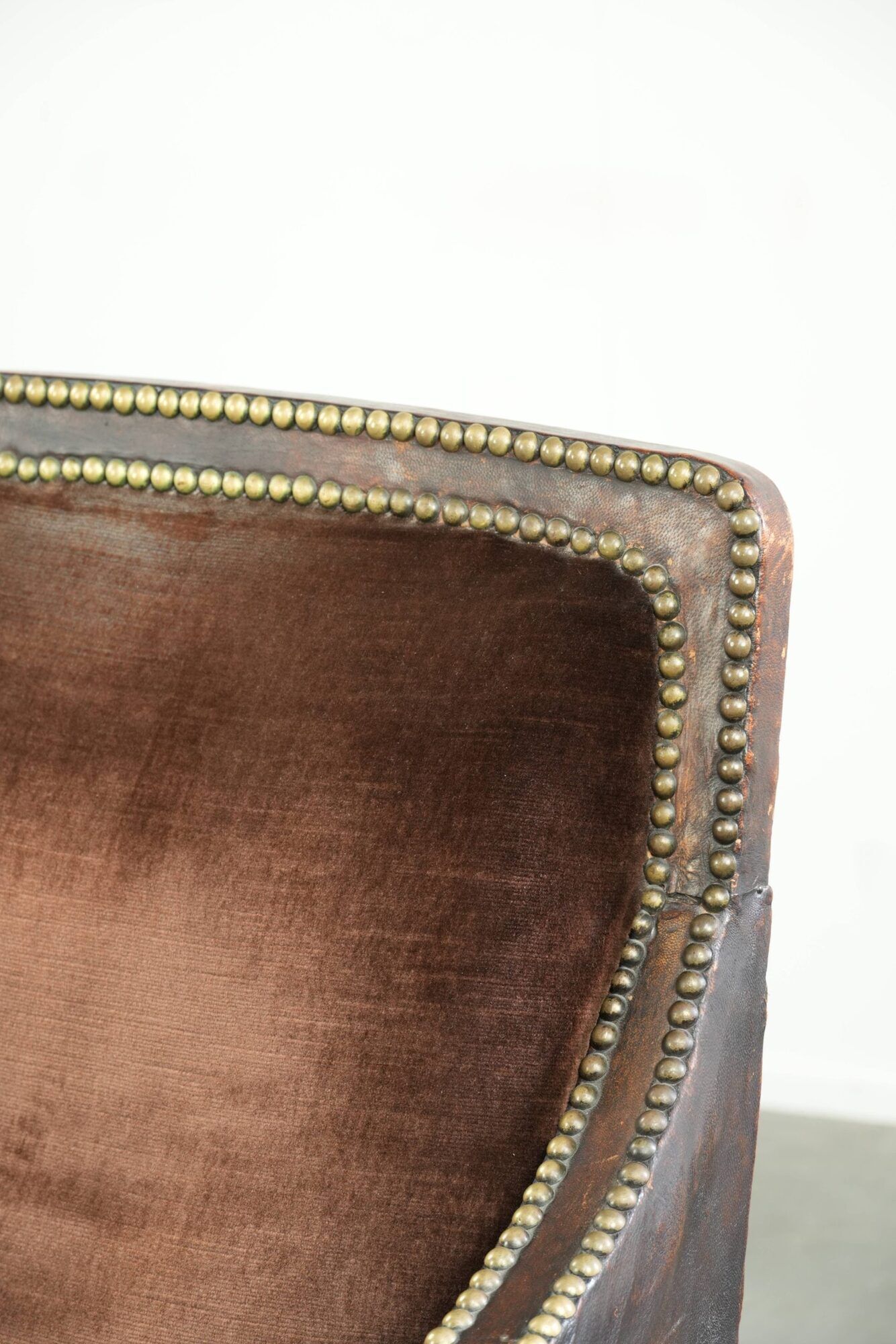 Art Deco design armchair finished in velvet and fitted with decorative nails