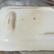 Very large rectangular dish with scalloped edges, made of fine glazed earthenware.