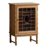 Scandinavian wardrobe in natural oak with a glass front.