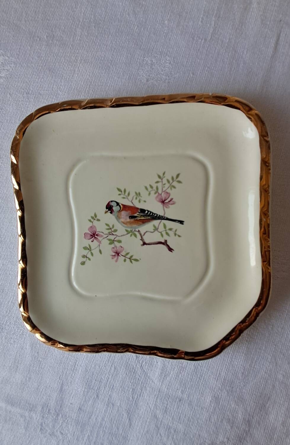 Trivet and bottle holder Salin, 1950s. Bird on branch.