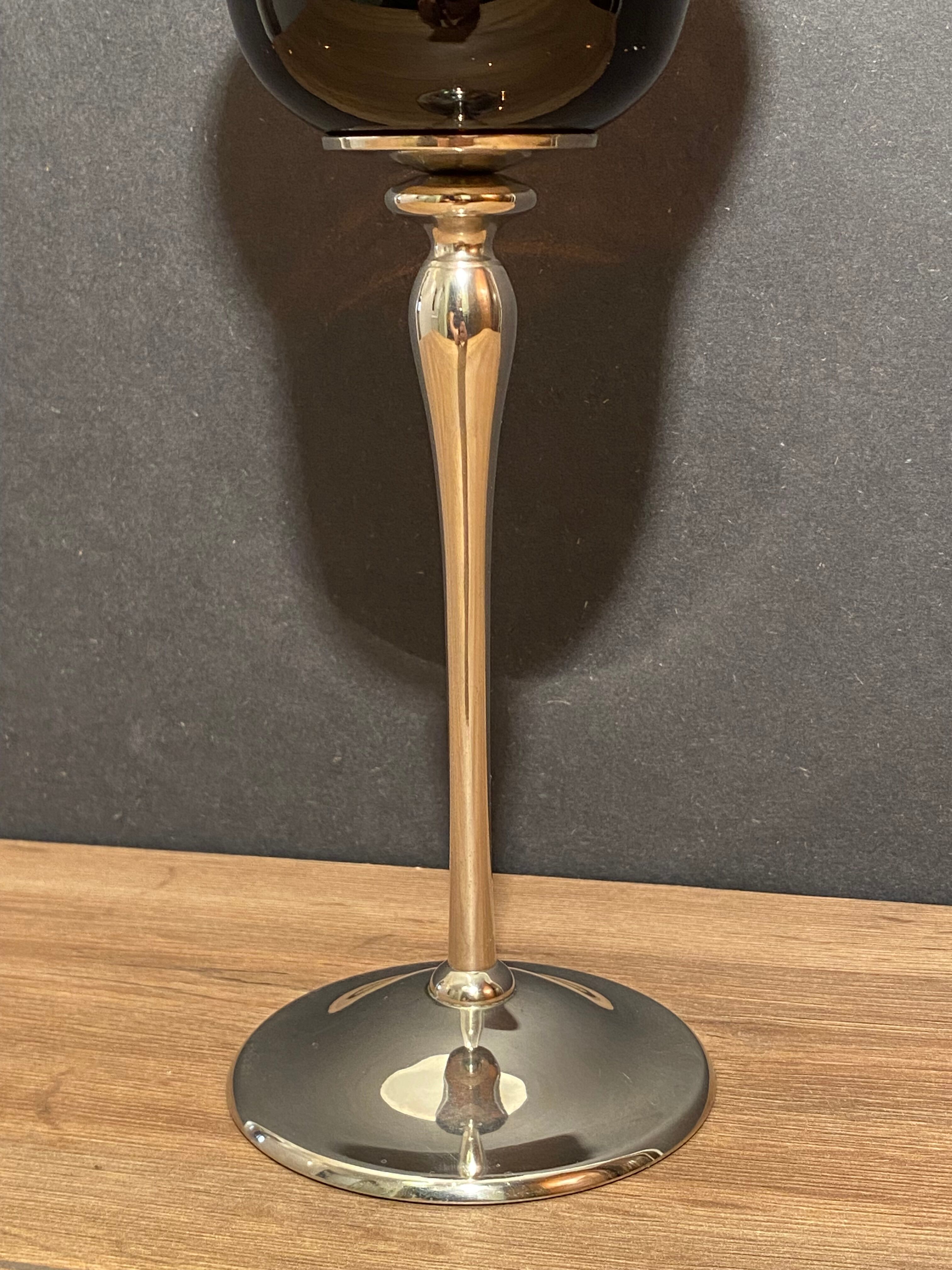 Photophore in tinted glass on high metal foot with silver patina