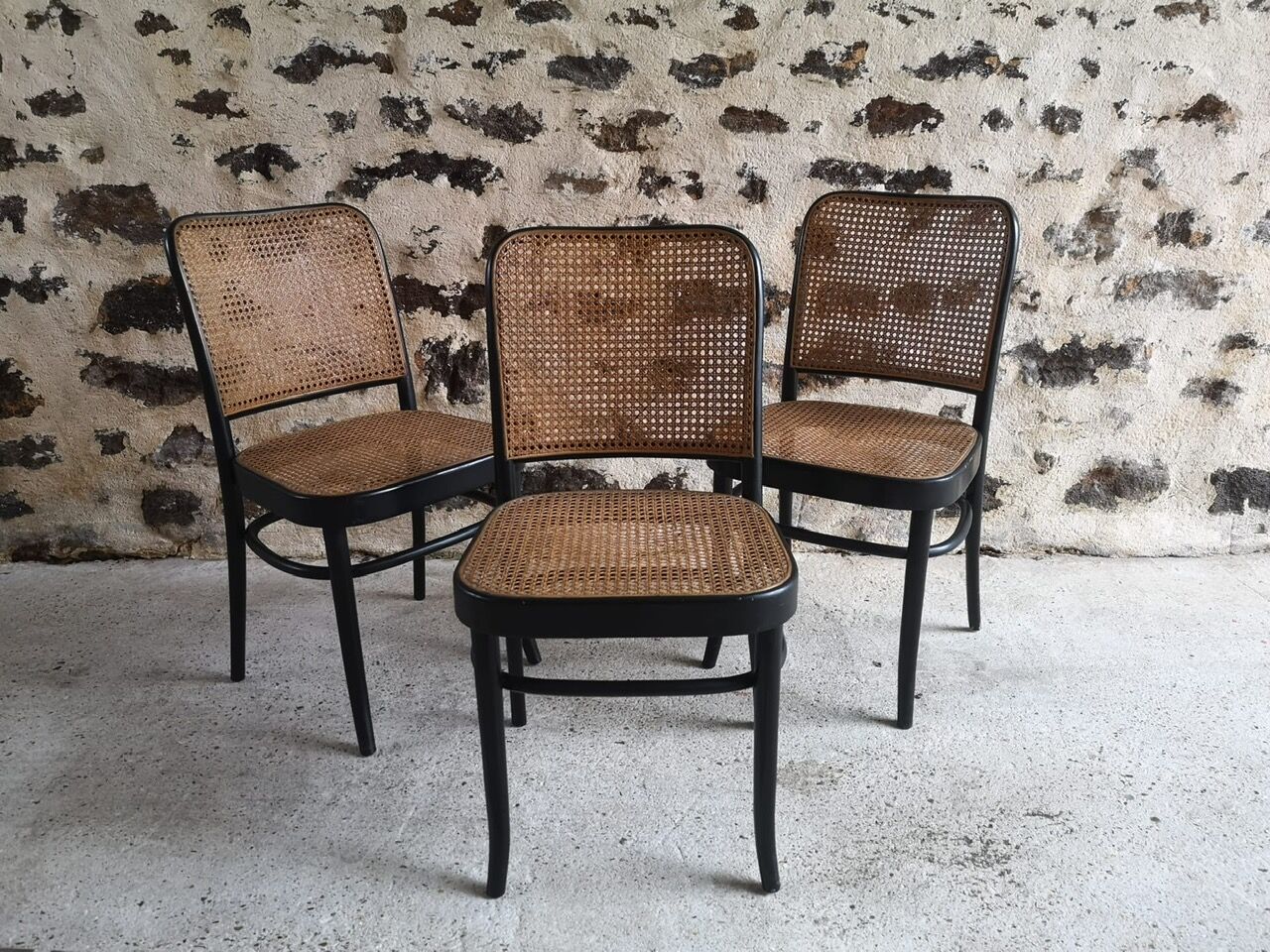 Blackened wooden chairs and cannage around 1980