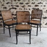Blackened wooden chairs and cannage around 1980