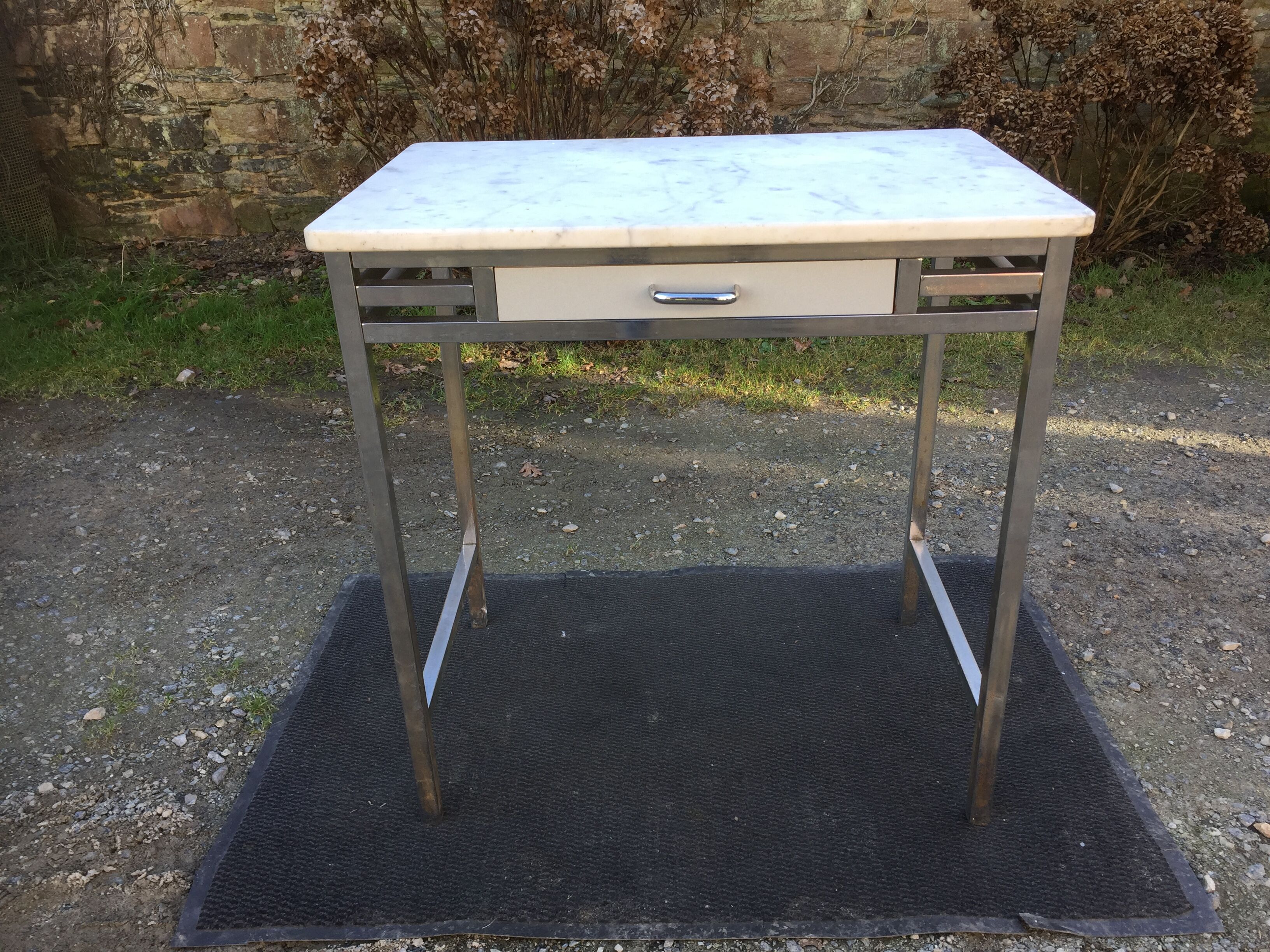 Vintage table with square chrome tubular metal base and marble top.
