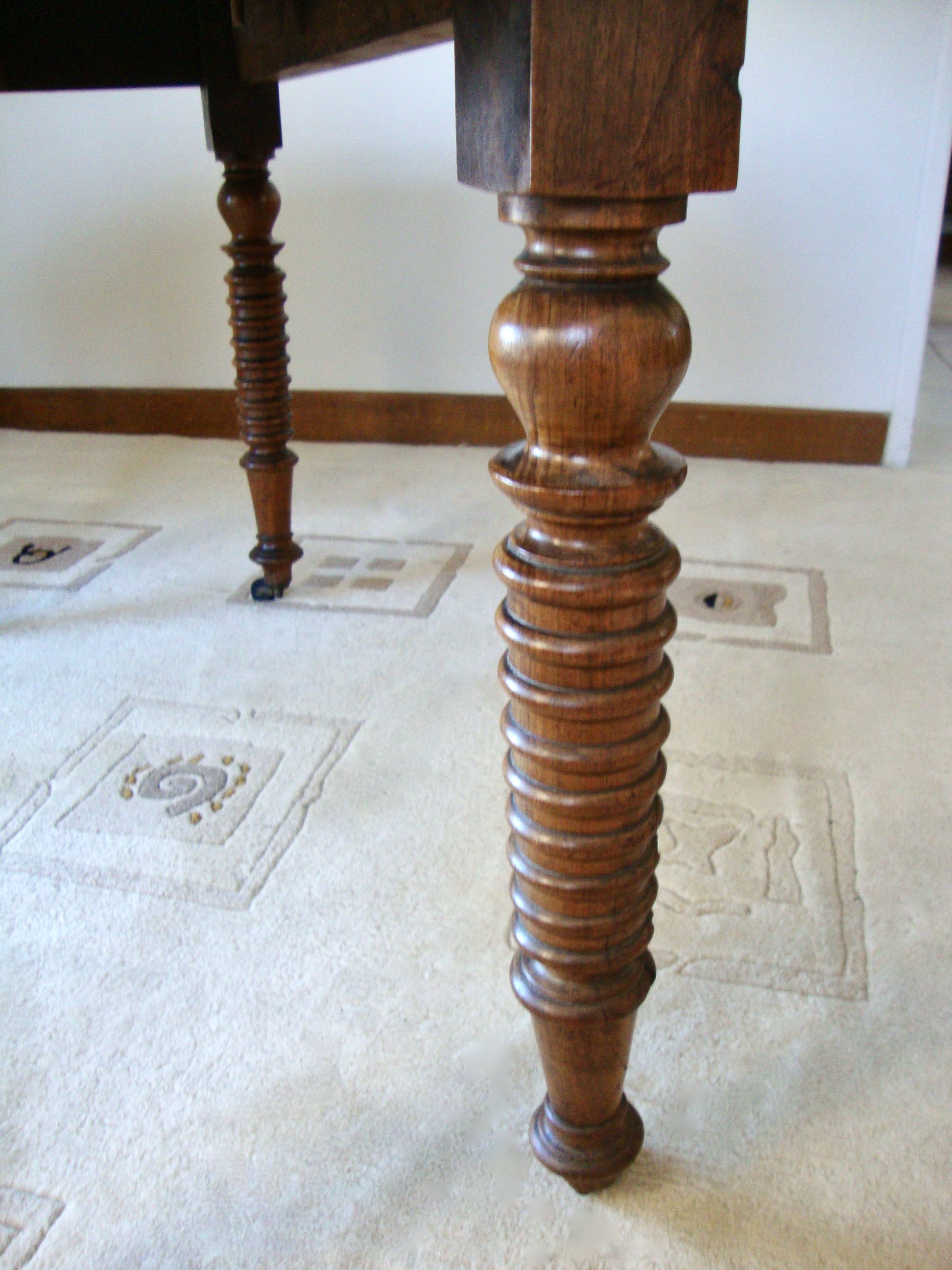 Mid-19th-century walnut round table with shutters, flaps