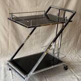 Modernist serving trolley in chromed metal and black smoked glass