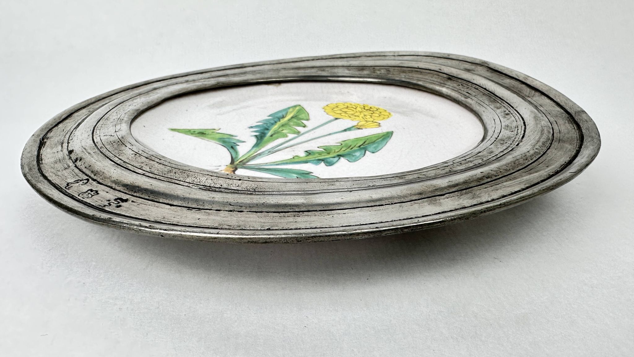 Decorative wall plate in earthenware and pewter with dandelion