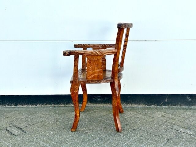 Hand stabbed teak armchair