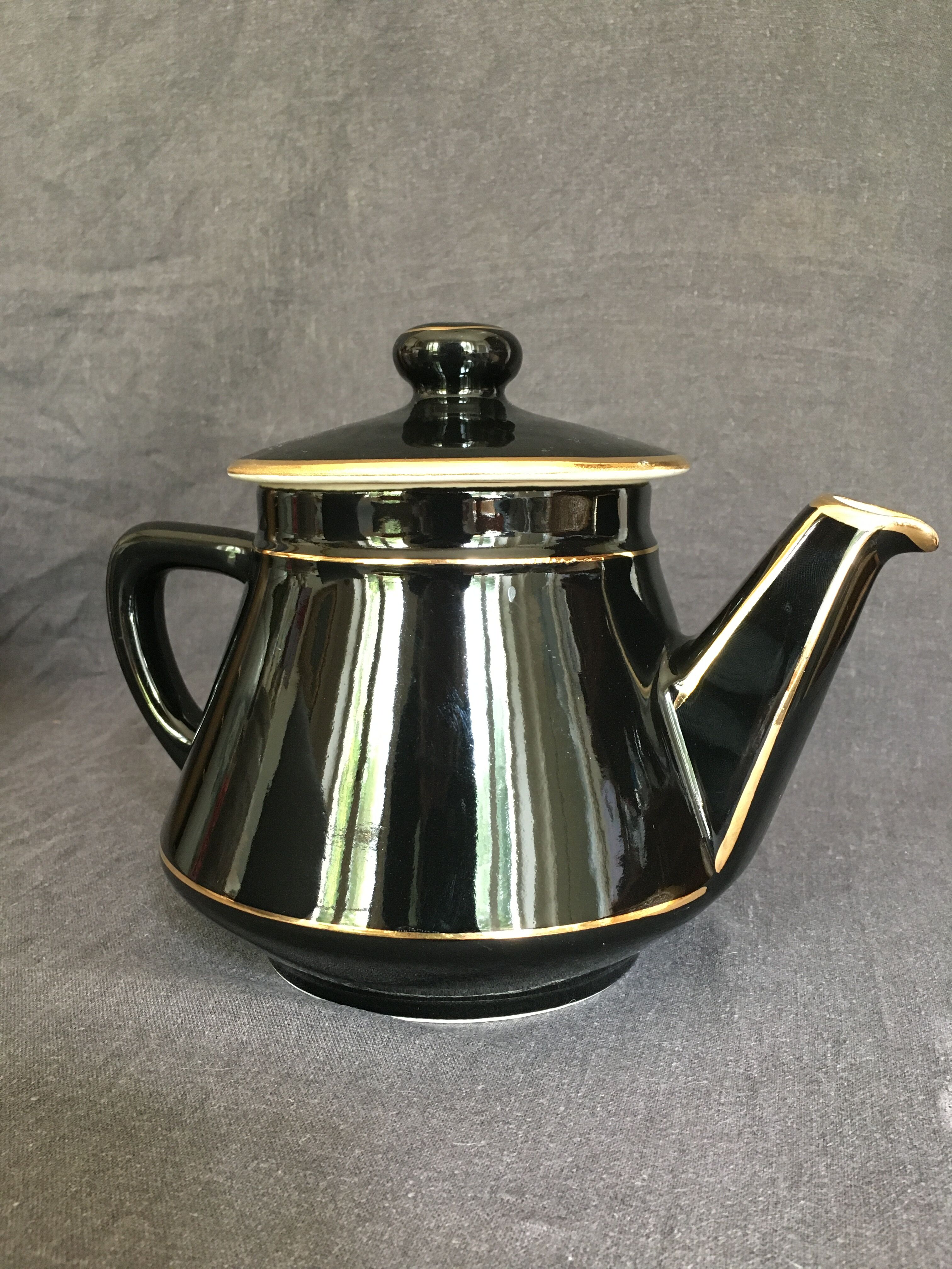 Black and gold ceramic coffee maker