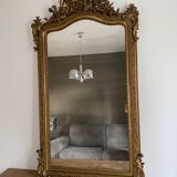 Late 19th century gilded mirror with decorated pediment. 155x88.