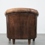 Vintage sheepskin club armchair with character and a beautiful patina
