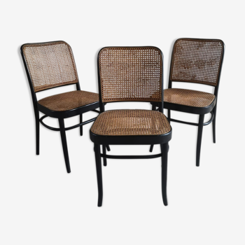 Blackened wooden chairs and cannage around 1980