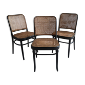 Blackened wooden chairs and cannage around 1980