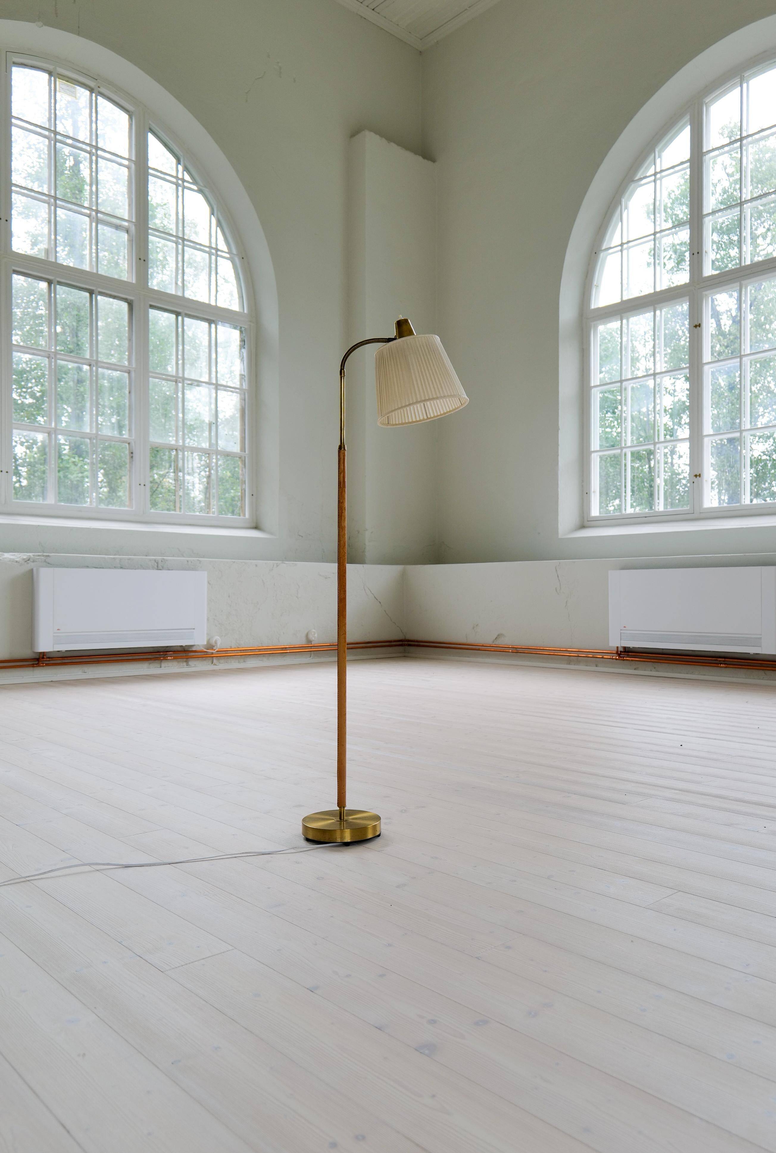 Mid-century brown leather and brass floor lamp, Falkenbergs Belysning, Sweden, 1960s.