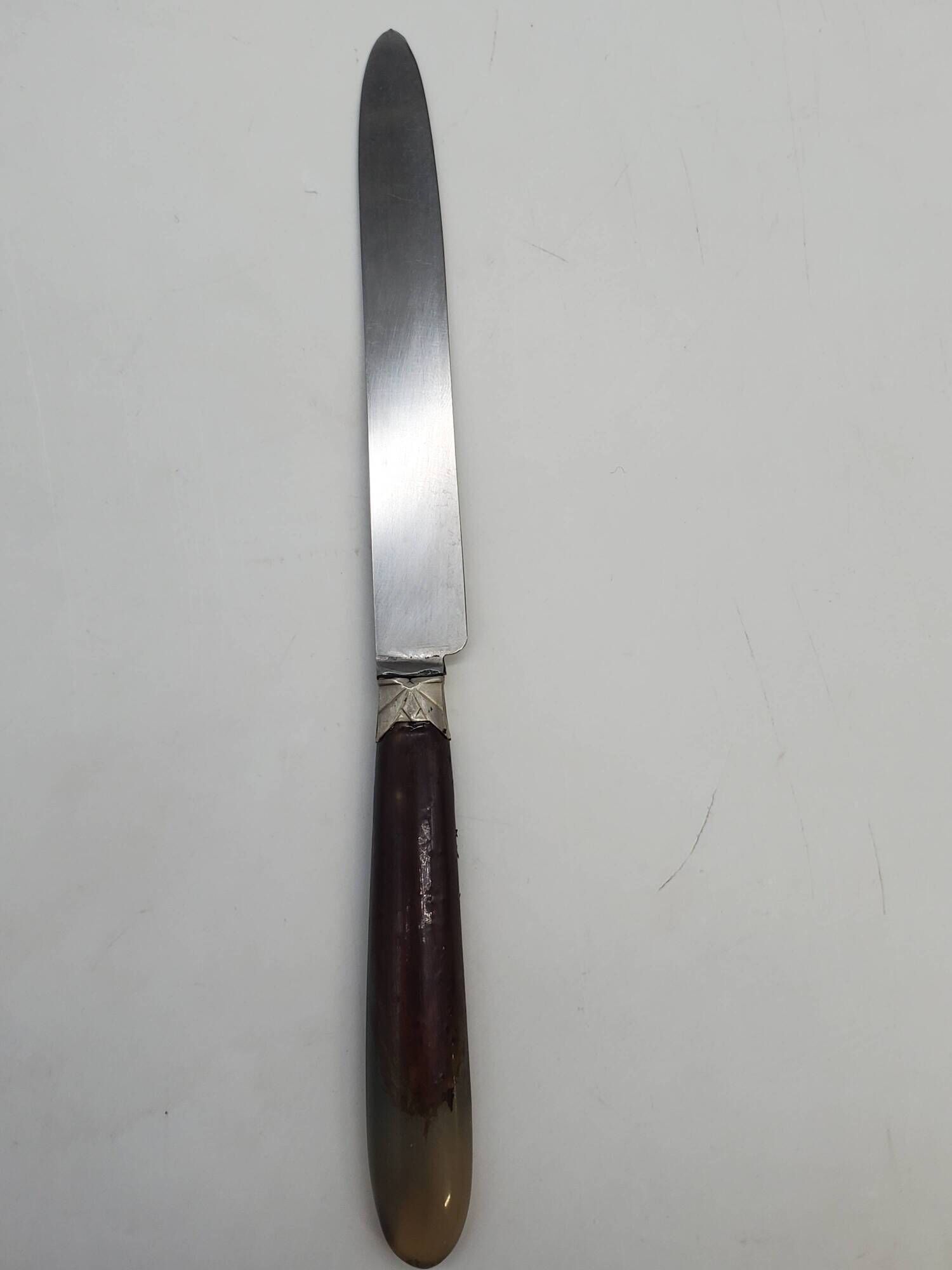 Set of 11 dessert knives with two-tone horn-effect resin handles.