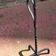 Old ashtray on twisted hammered wrought iron legs, vintage decor.
