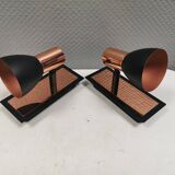 A pair of wall lamps from Eglo, in copper color and black.