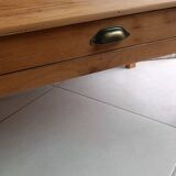 Coffee table with raw wood and a large drawer.