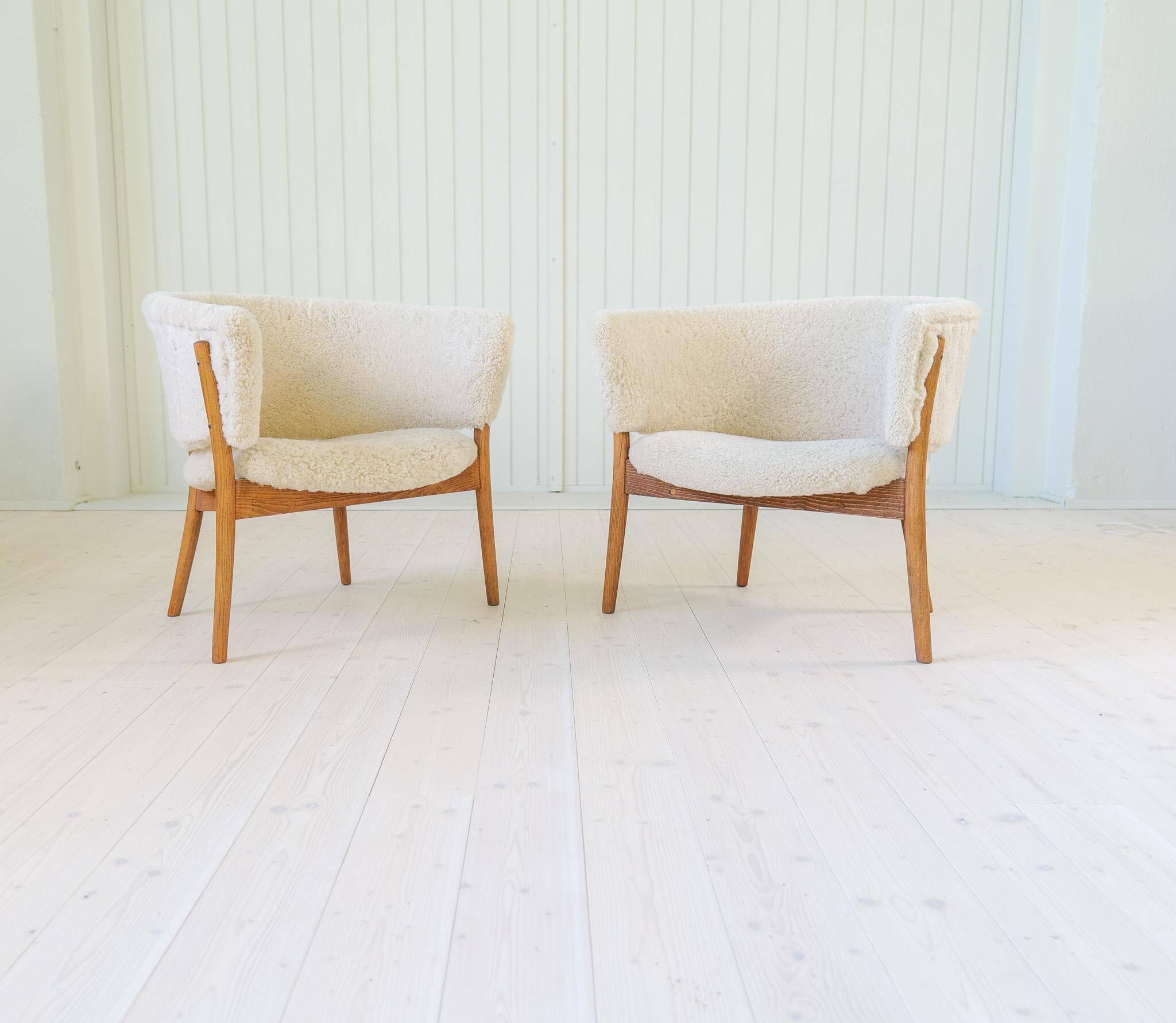 Mid-century lounge chairs in sheepskin/shearling and stained wood, Sweden, 1962.