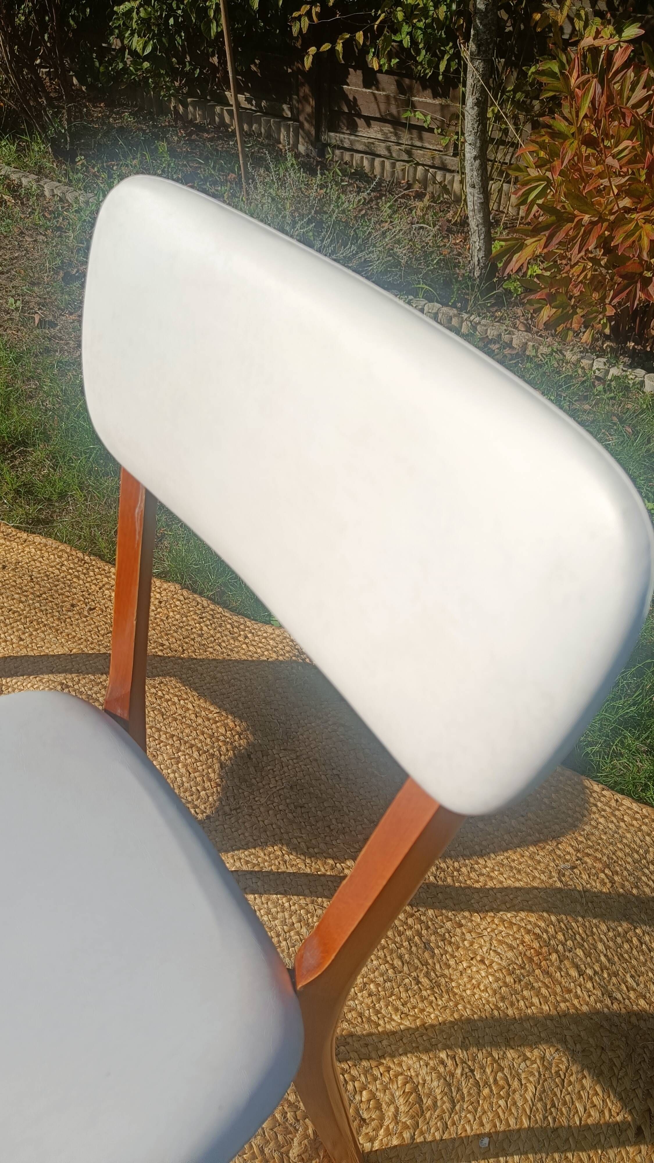 vintage wooden chairs with white faux leather