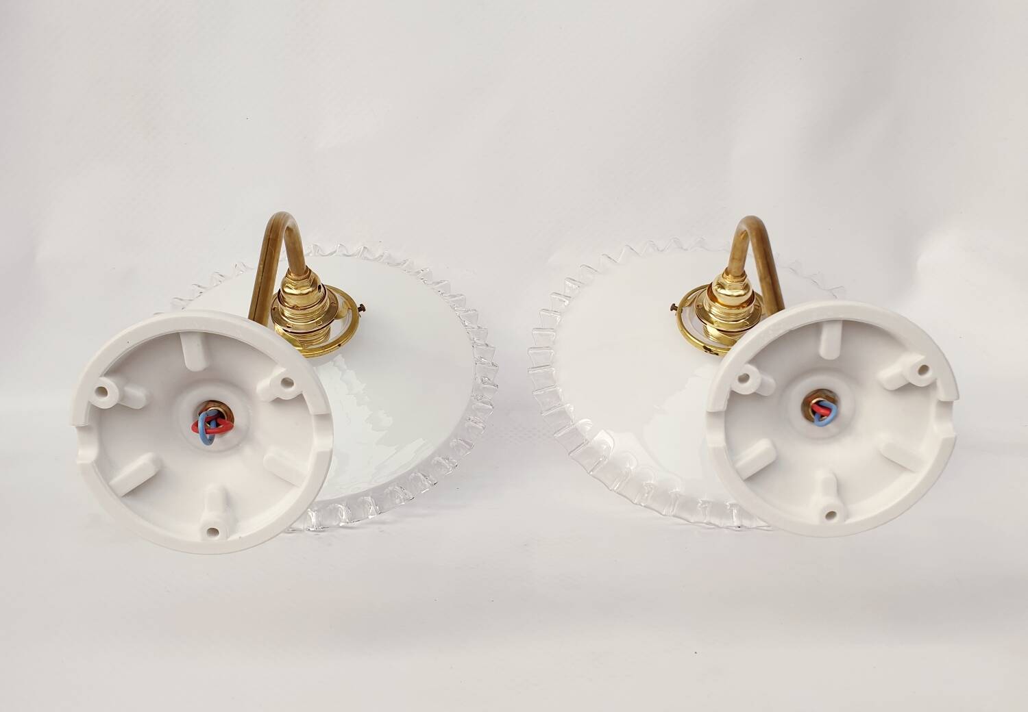 Swan neck sconces in serrated opaline