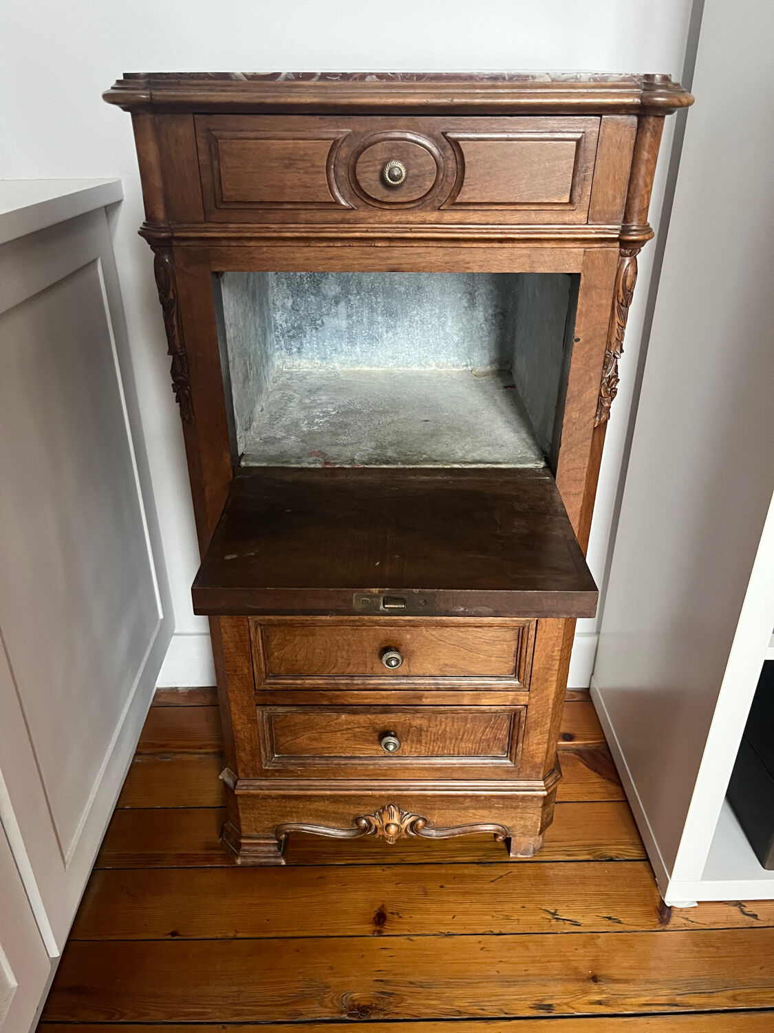 Solid wood storage furniture with a marble top.