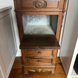 Solid wood storage furniture with a marble top.