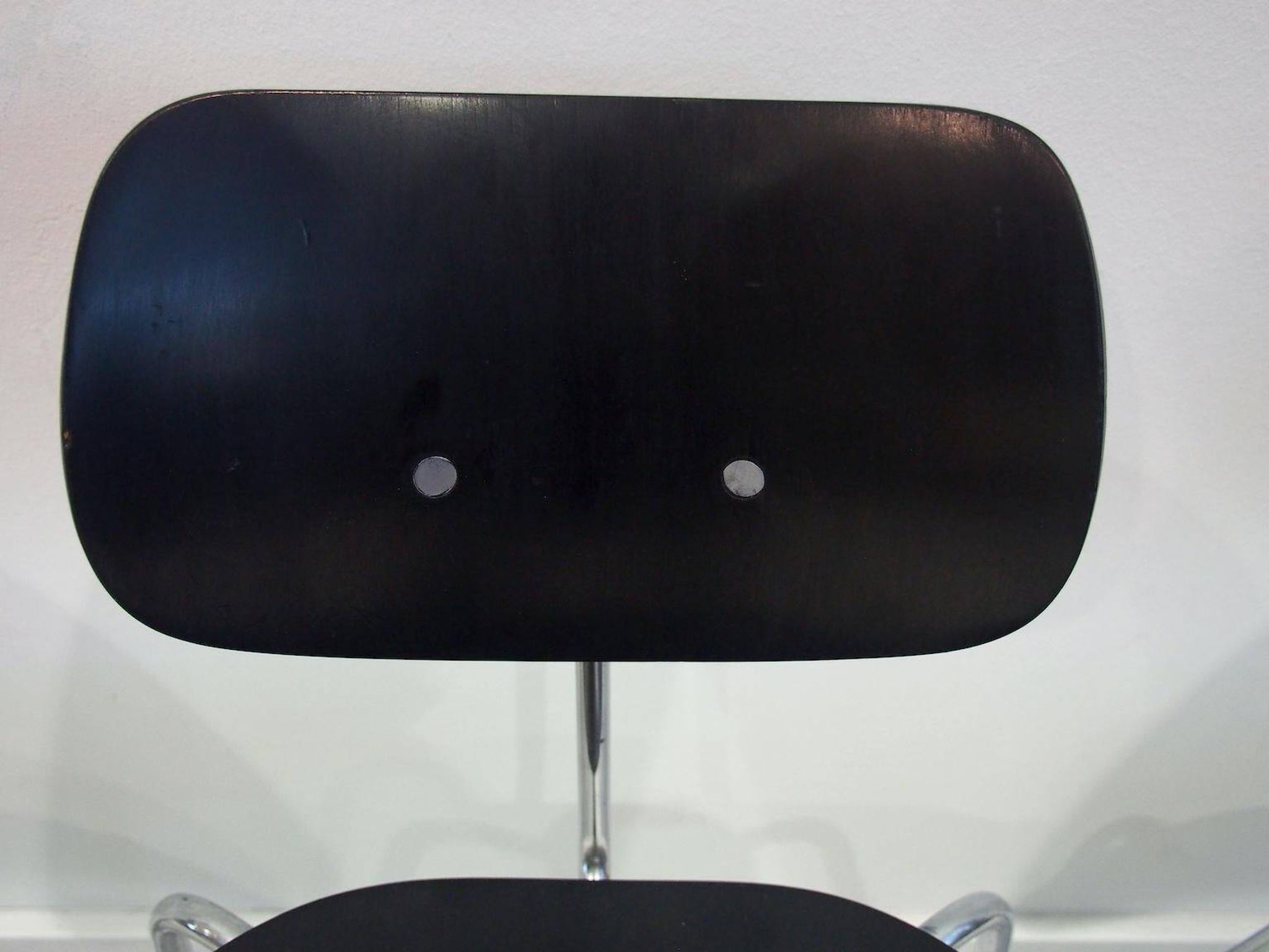 Set of four Egon Eiermann model SE 68 chairs in black lacquered plywood and steel.