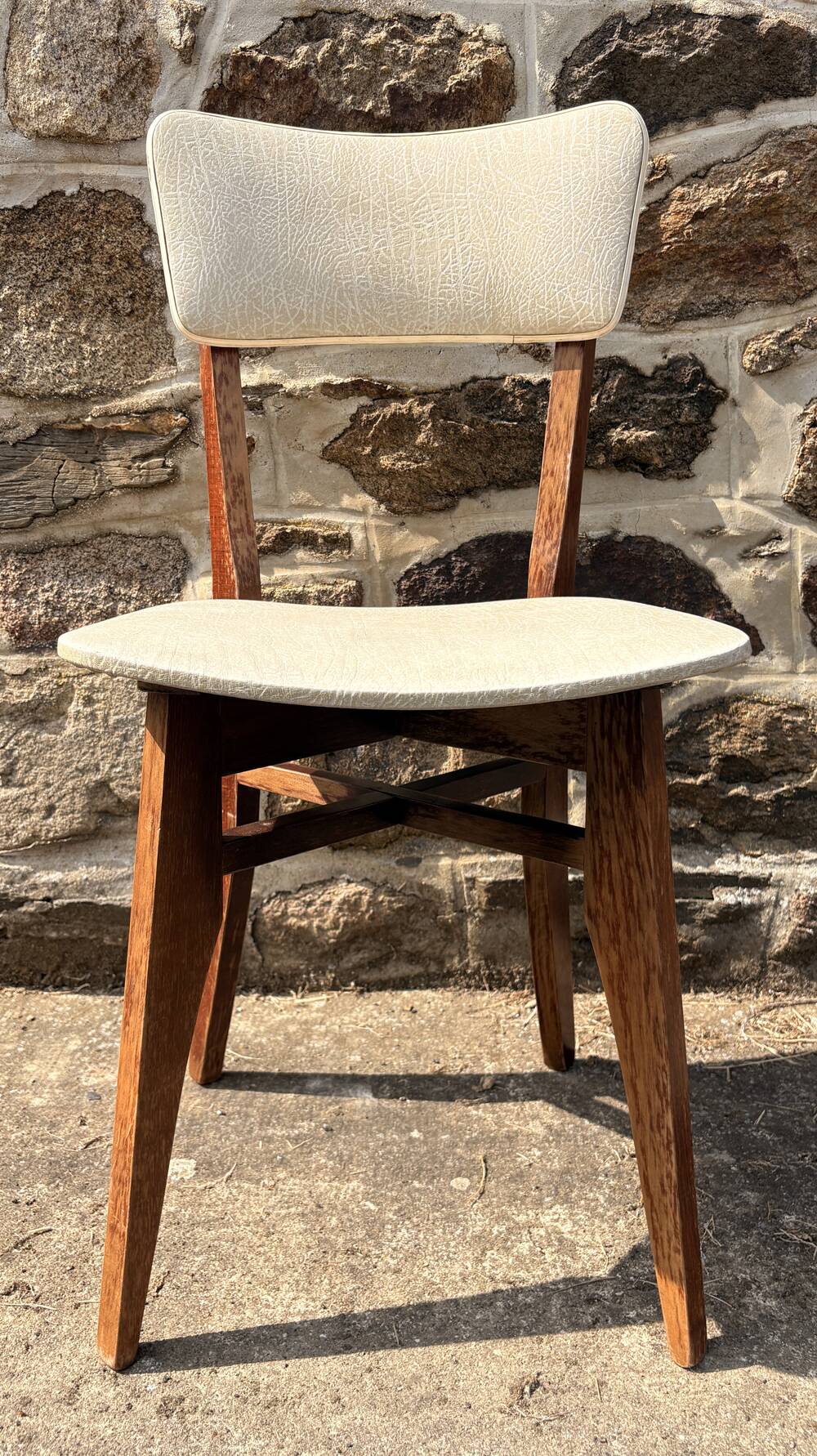 Pair of vintage chairs with upholstered backrest and seat, 1950s style.